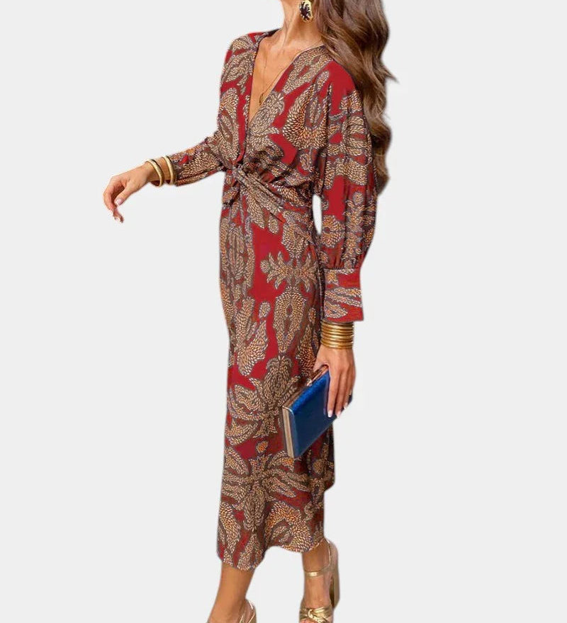 Red long-sleeve V-neck midi dress with draped tie waist and ornate print