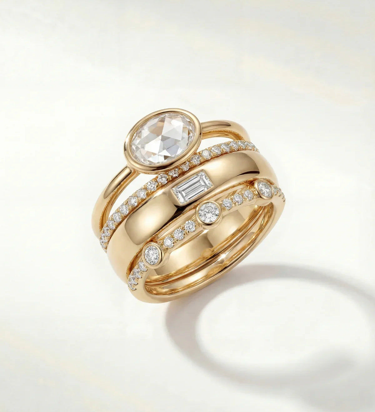 Gold ring set with oval center stone and pavé diamond bands