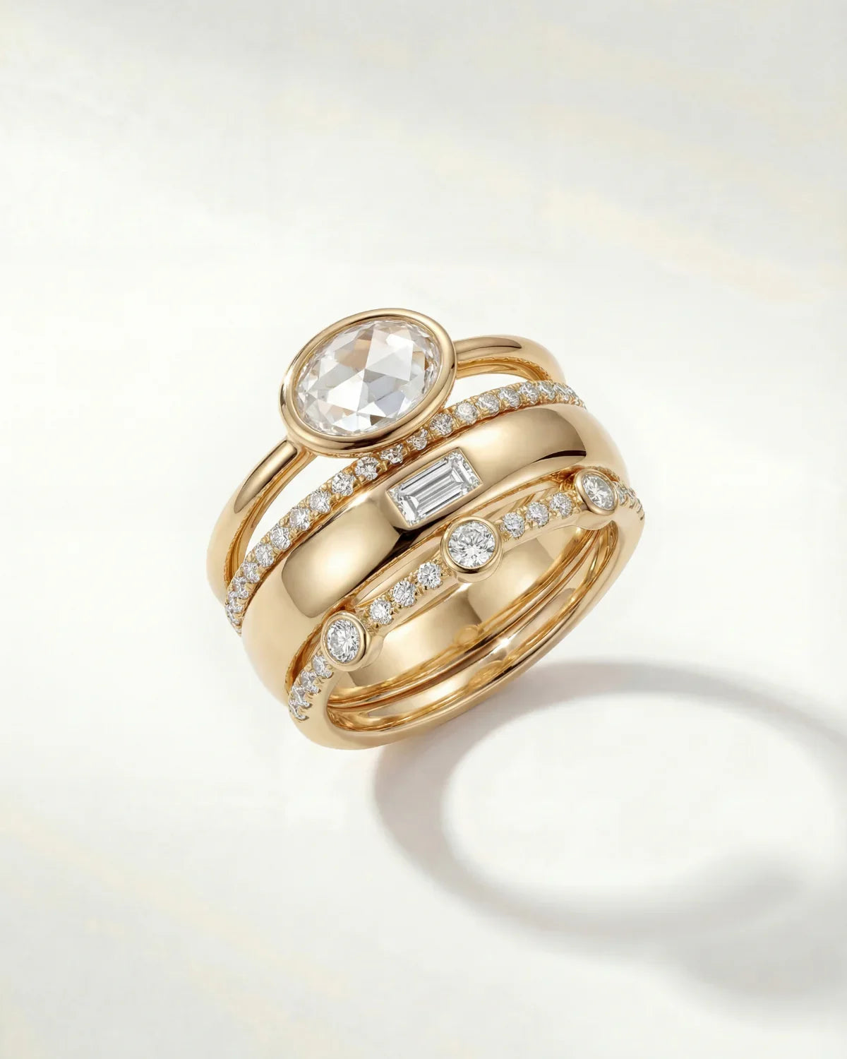 Gold ring set with oval center stone and pavé diamond bands