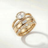 Gold ring set with oval center stone and pavé diamond bands