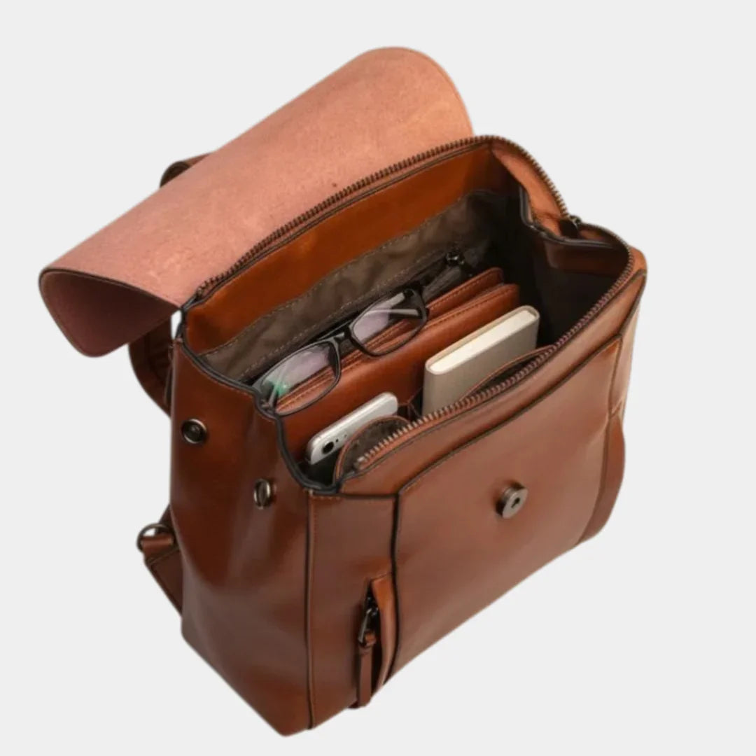 Caramel leather backpack open view showing interior and front organizer compartments