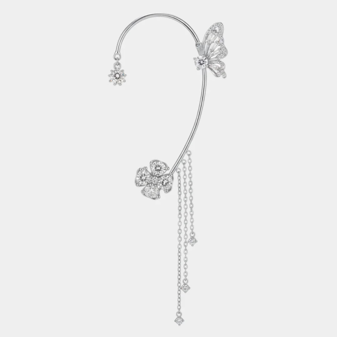 Silver magical ear cuff with butterfly and flower charms, dangling chain tassel