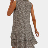 Back view of dark patterned strappy dress with tiered ruffle hem