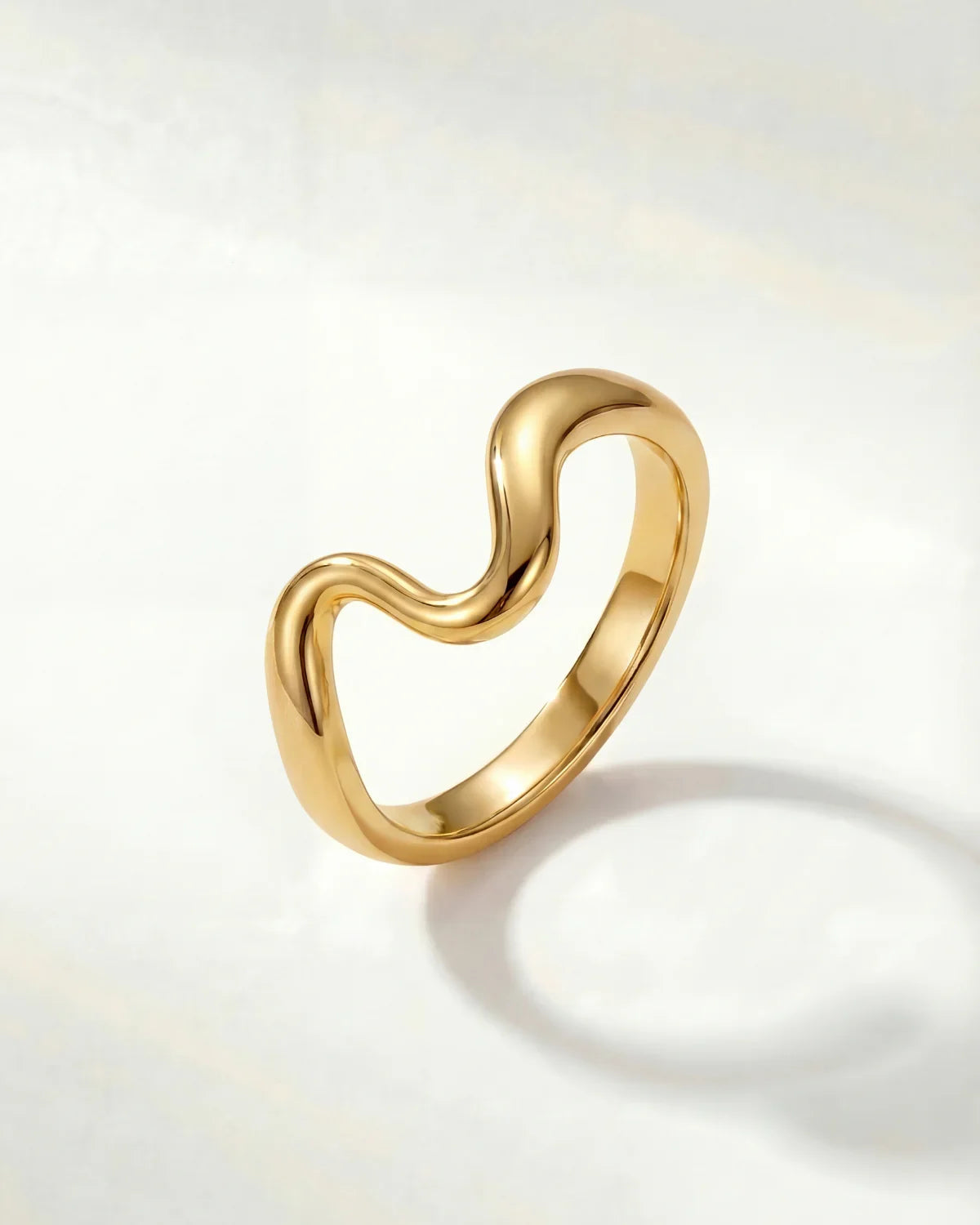 Gold wavy ring with a smooth polished band