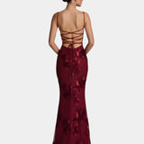 Burgundy floor-length gown with spaghetti straps, lace-up back, and floral embellishment
