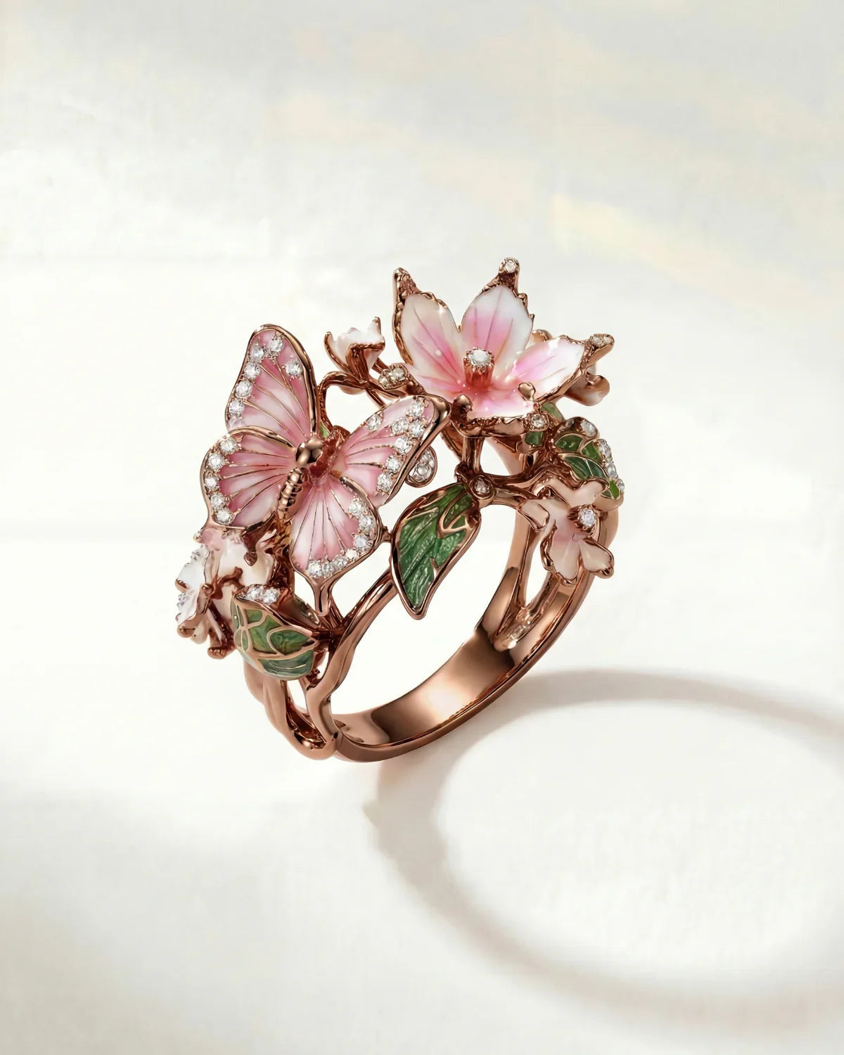 Bronze spring ring with pink flower, butterfly details and green leaf accents
