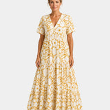 Yellow floral maxi dress with V-neck, short sleeves, and tiered maxi skirt