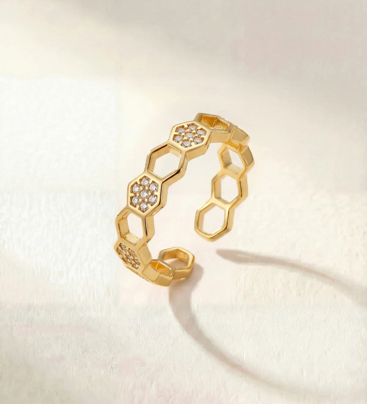 Gold geometric link ring with small round clear stones