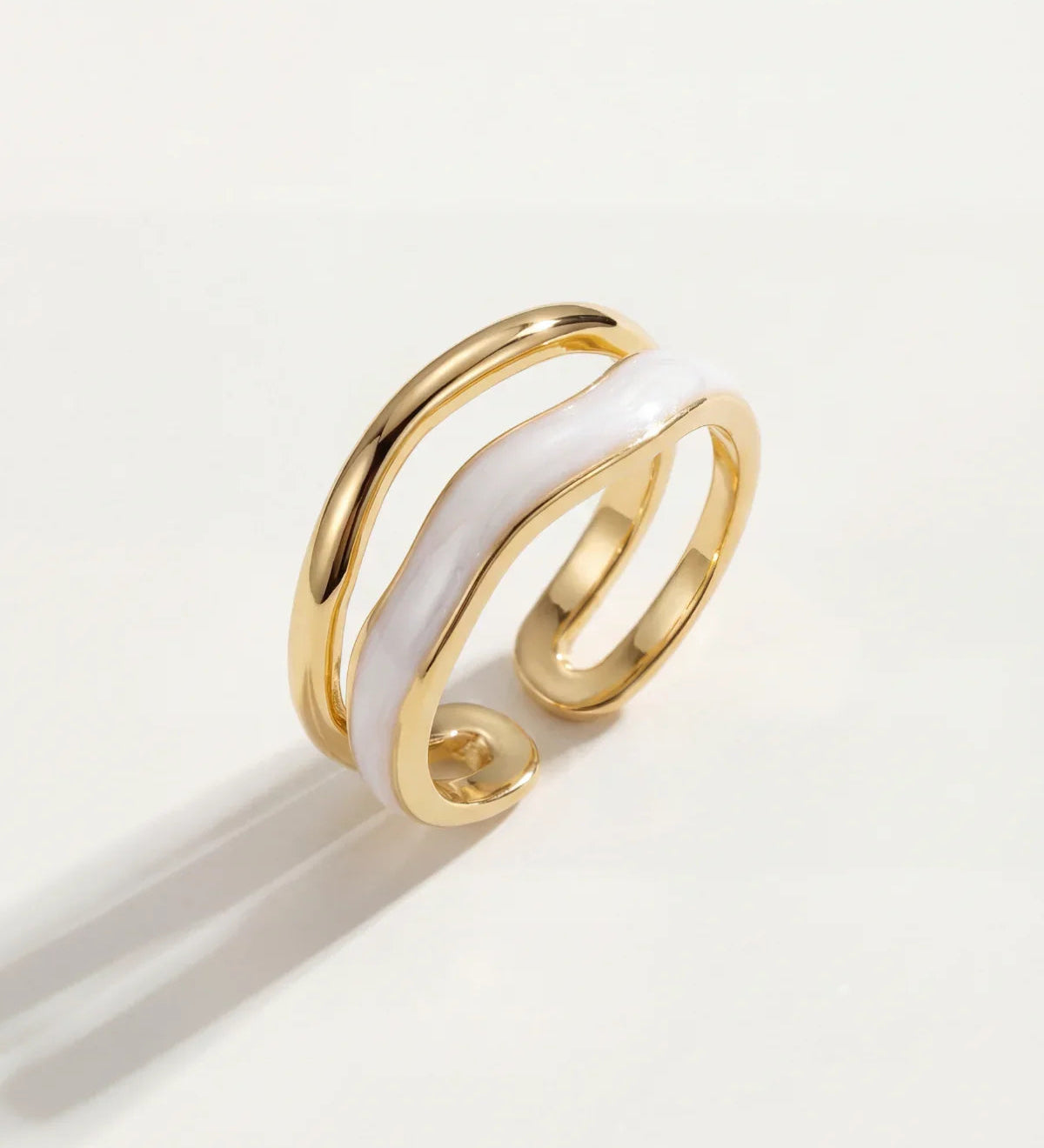 Adjustable gold triple-band ring with glossy white inlay stripe