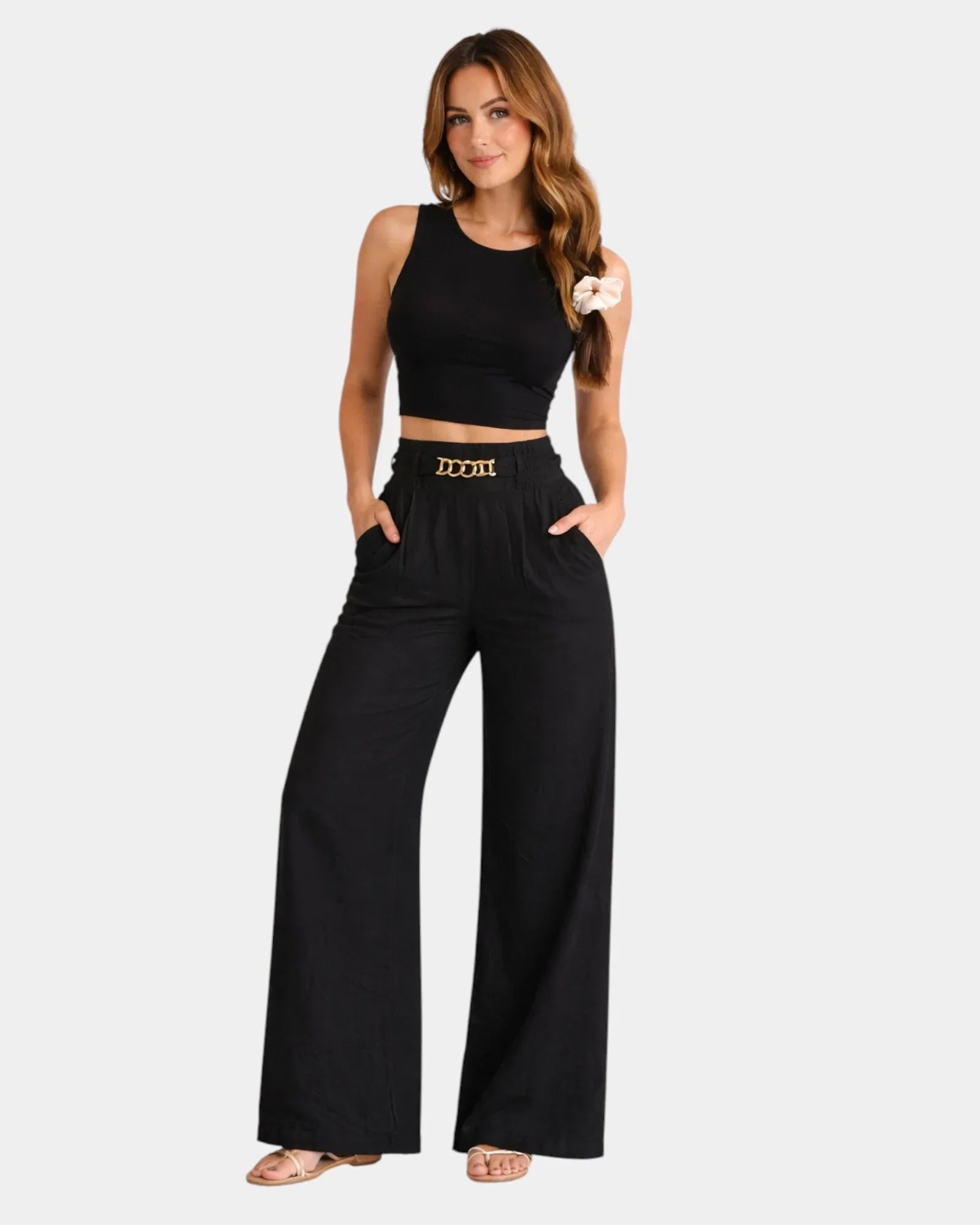 Black high-waist wide-leg pants with gold chain belt detail