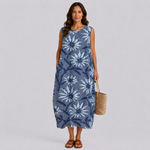 Sleeveless blue midi dress with white floral print, round neckline and side pockets