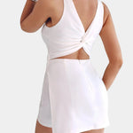 White sleeveless mini dress-effect jumpsuit, open back twist knot detail