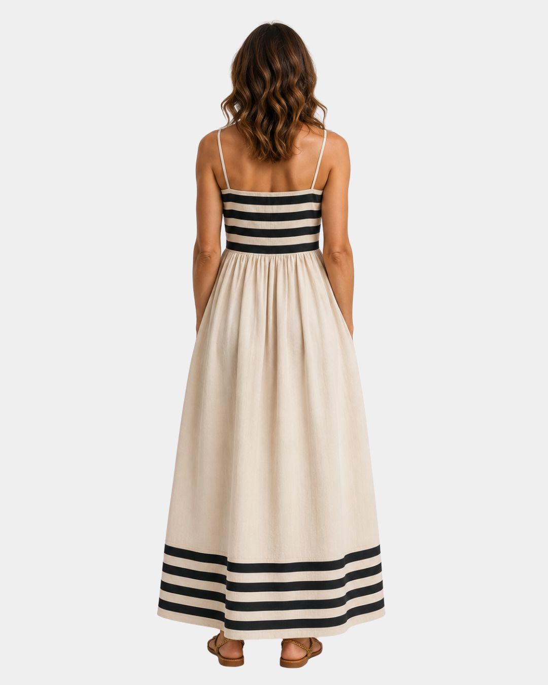 Back view of beige long striped dress with spaghetti straps and striped hem