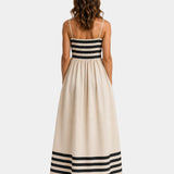 Back view of beige long striped dress with spaghetti straps and striped hem