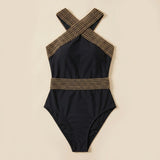 Black one-piece swimsuit with gold lattice halter straps and fitted waist band