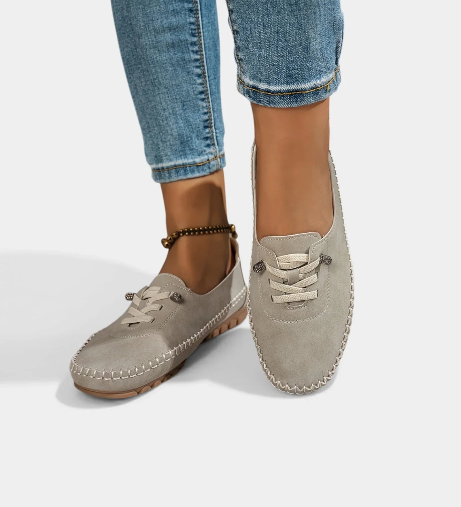 Gray suede lace-up loafers with stitch-trimmed apron toe and low profile sole.