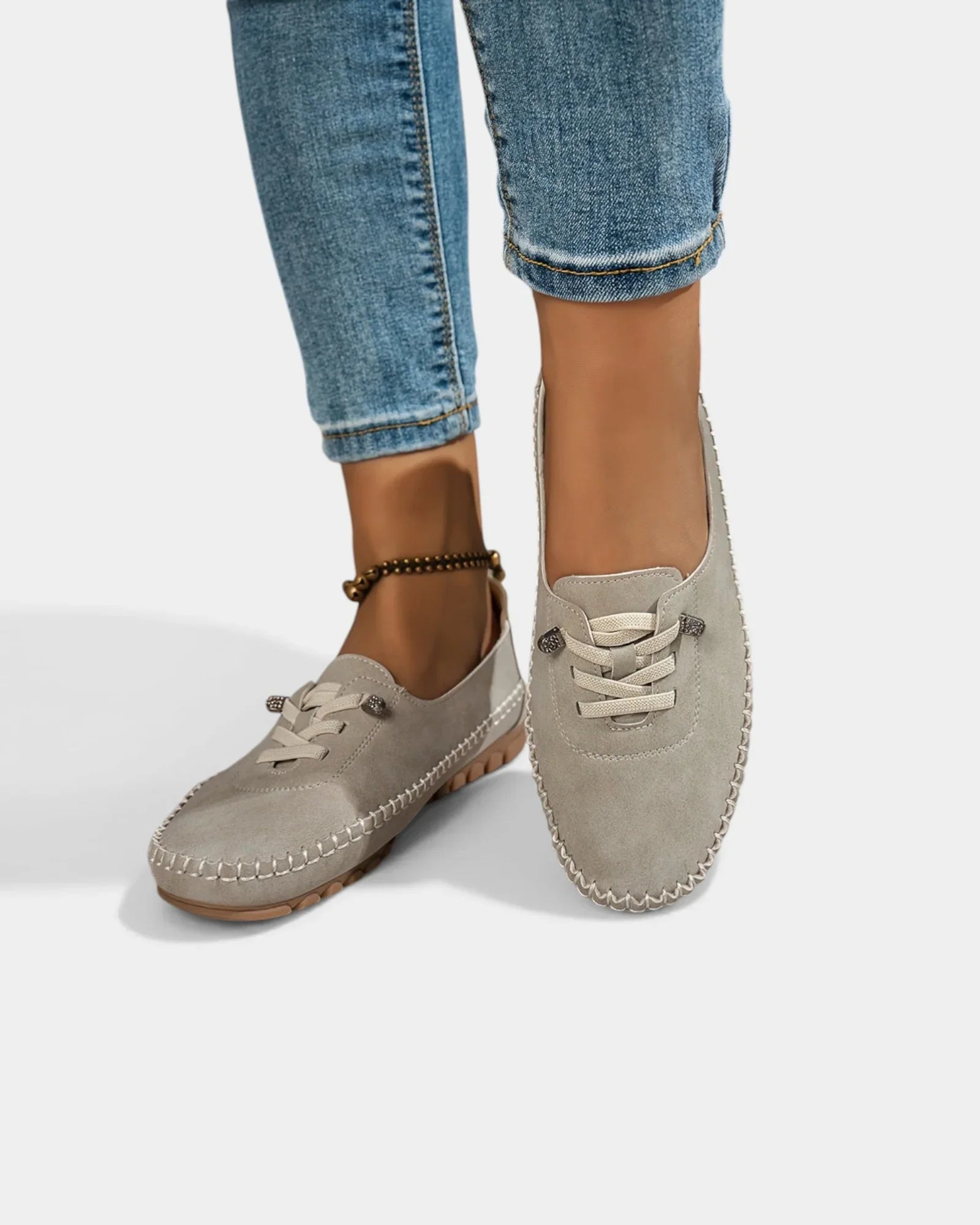 Gray suede lace-up loafers with stitch-trimmed apron toe and low profile sole.