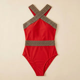 Red one-piece swimsuit with gold lattice halter straps and crisscross back