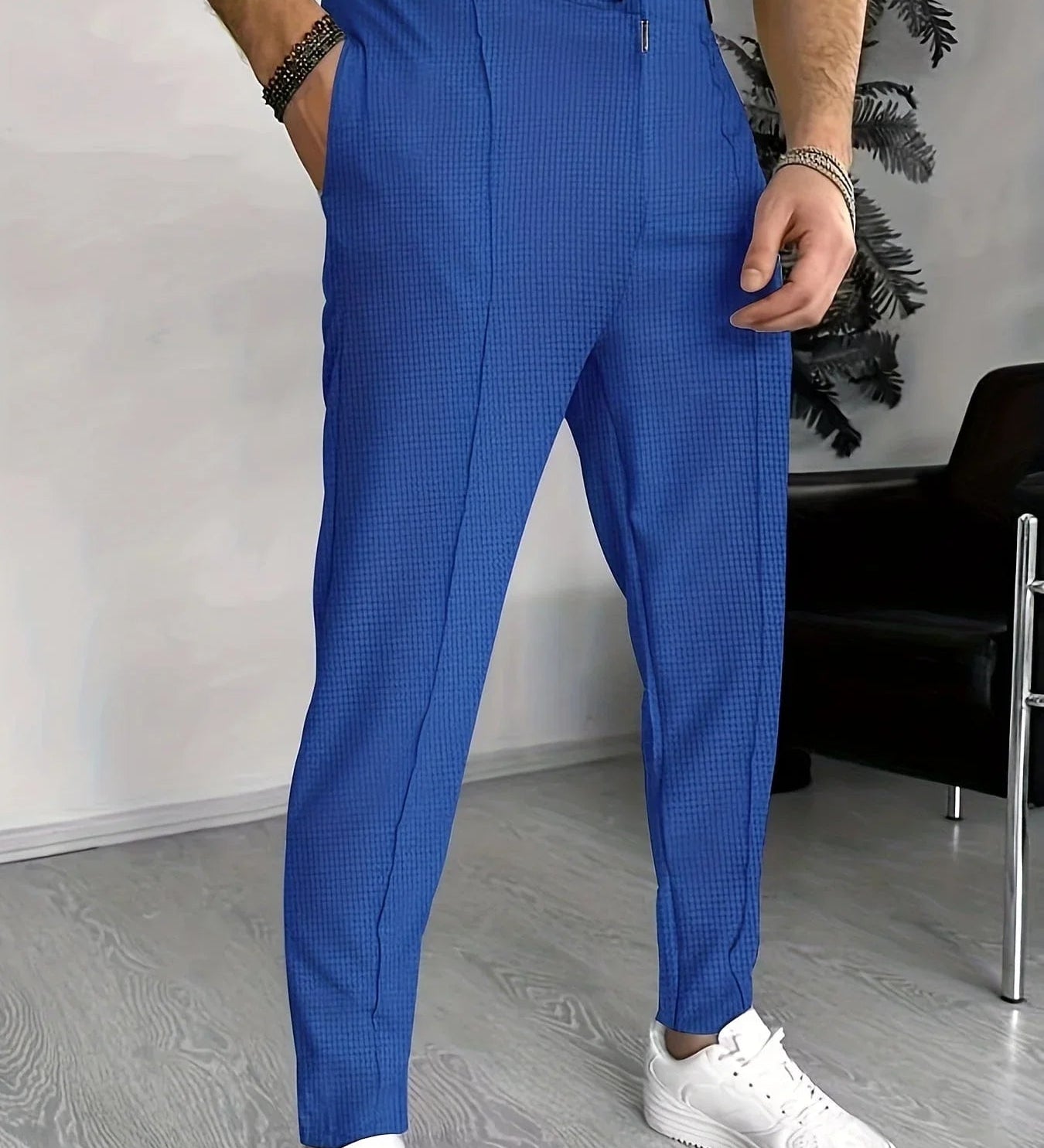 Blue checkered sports pants with elastic waistband and drawstring, tapered legs