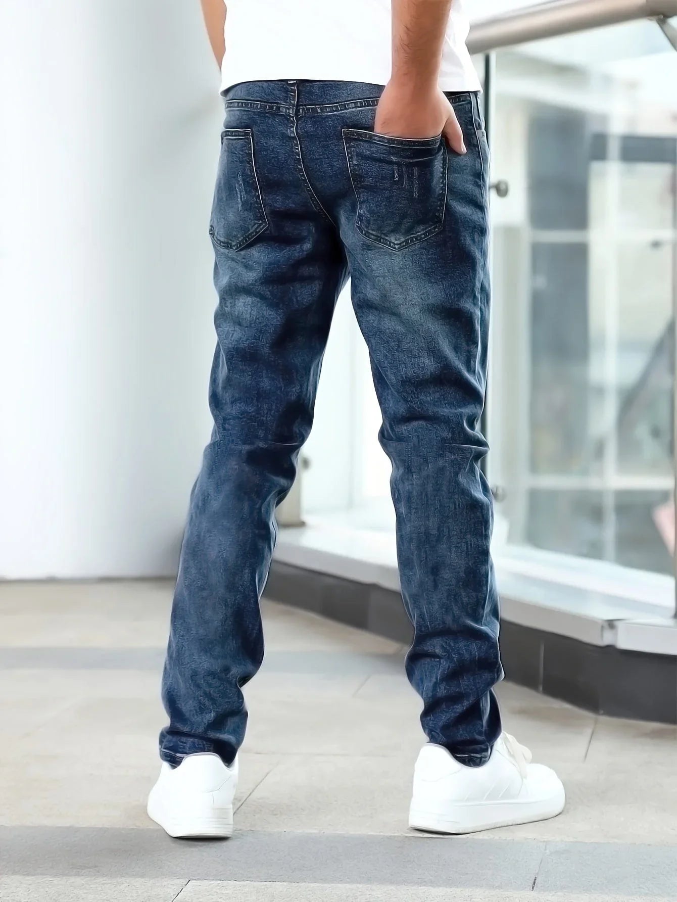 Dark blue casual stretch jeans, rear view with five-pocket construction and belt loops