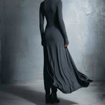 Dark long-sleeve maxi dress, back view, fitted bodice with draped flowing skirt