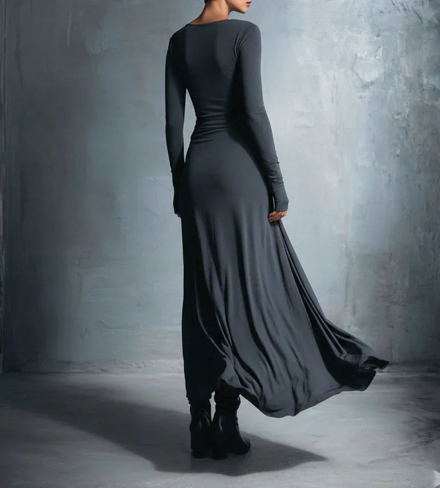 Dark long-sleeve maxi dress, back view, fitted bodice with draped flowing skirt