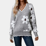Gray V-neck knit sweater with long sleeves and white floral pattern
