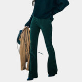Dark green corduroy flared pants with fitted waist and long bell legs