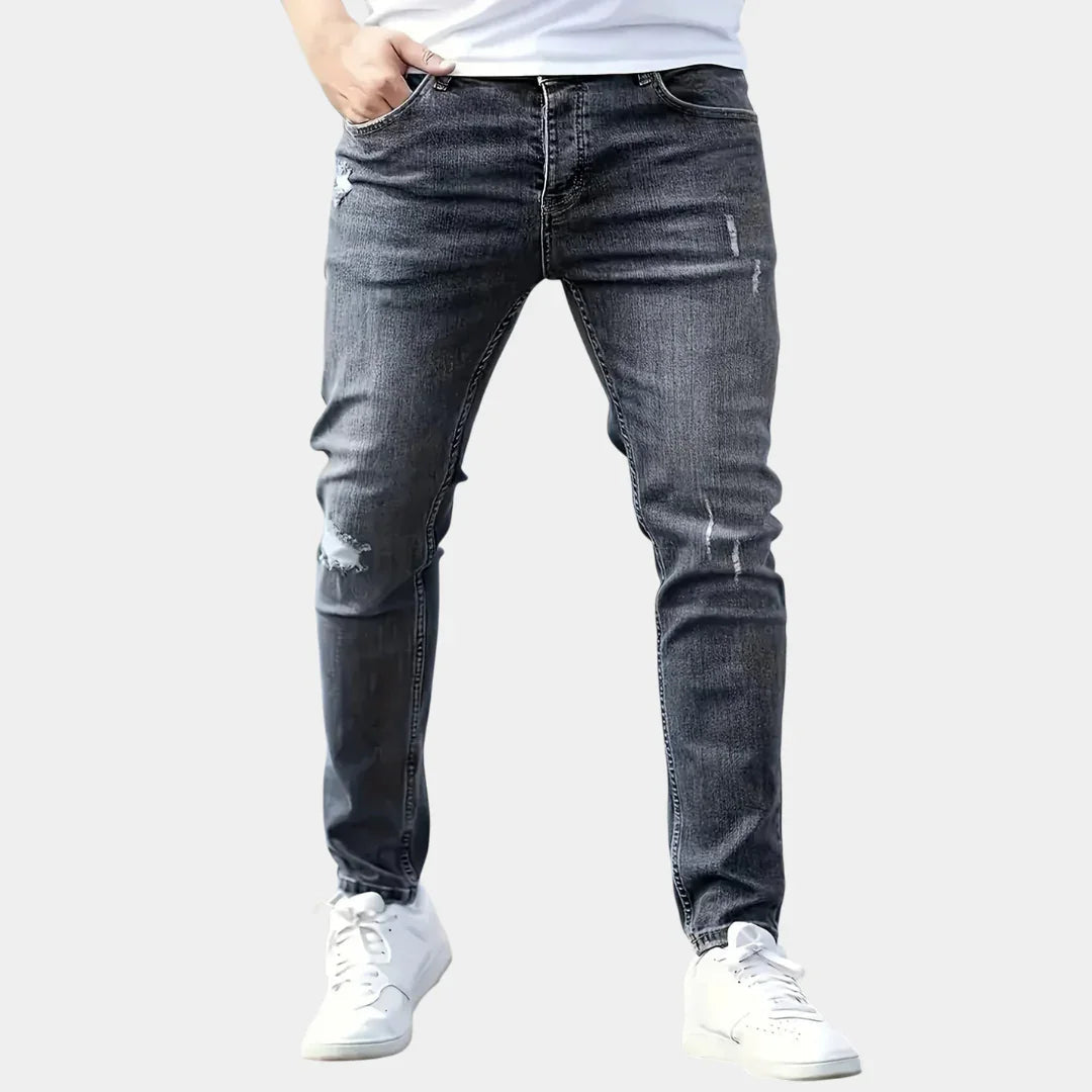Slim-fit ripped jeans in dark wash, distressed knees and side seams