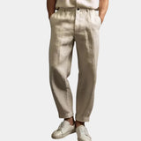 Beige summer pants with button waistband, tapered legs, ankle-length cuffs