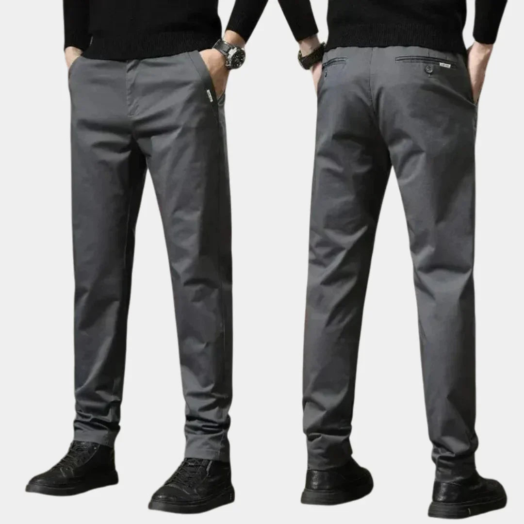 Dark gray slim chino pants with button closure, tapered legs, side pockets