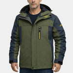 Olive-green winter jacket with black faux-fur hood, yellow zipper, navy side panels