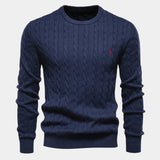 Men's navy blue cable-knit crewneck sweater with long sleeves and small chest logo