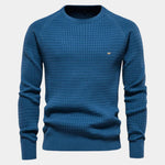 Men's blue knit pullover sweater with crew neck, ribbed cuffs and hem, small chest logo.