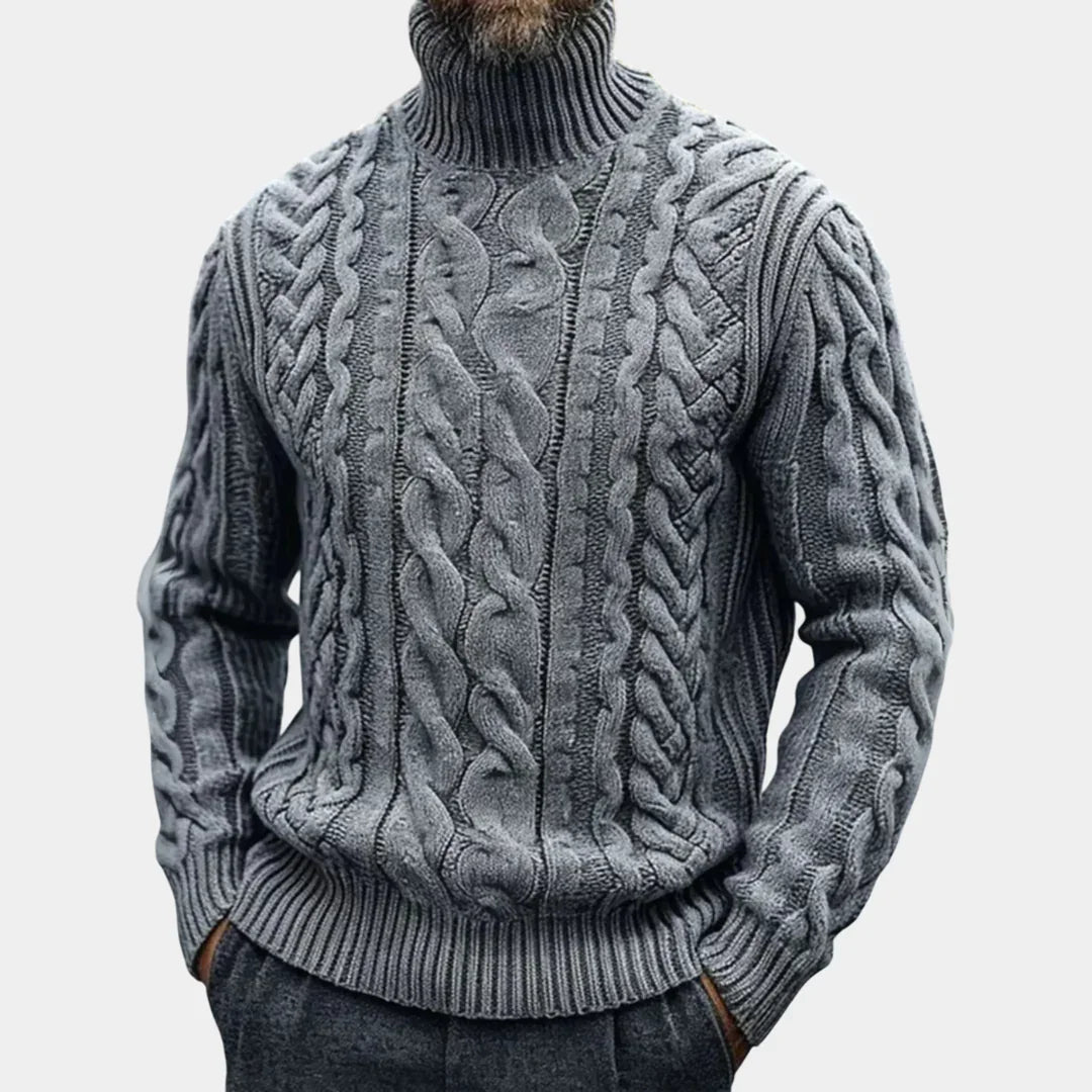 Gray cable knit turtleneck sweater with twisted braided texture, ribbed cuffs and hem.