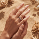 Silver wavy open-band ring close-up on fingers