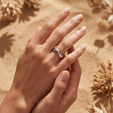 Silver wavy open-band ring close-up on fingers