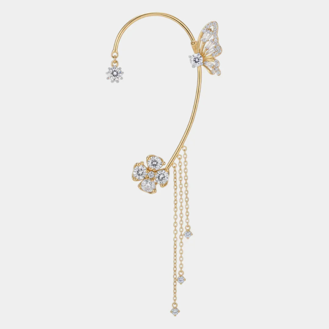Gold magical ear cuff with butterfly and flower charms, dangling chain tassel