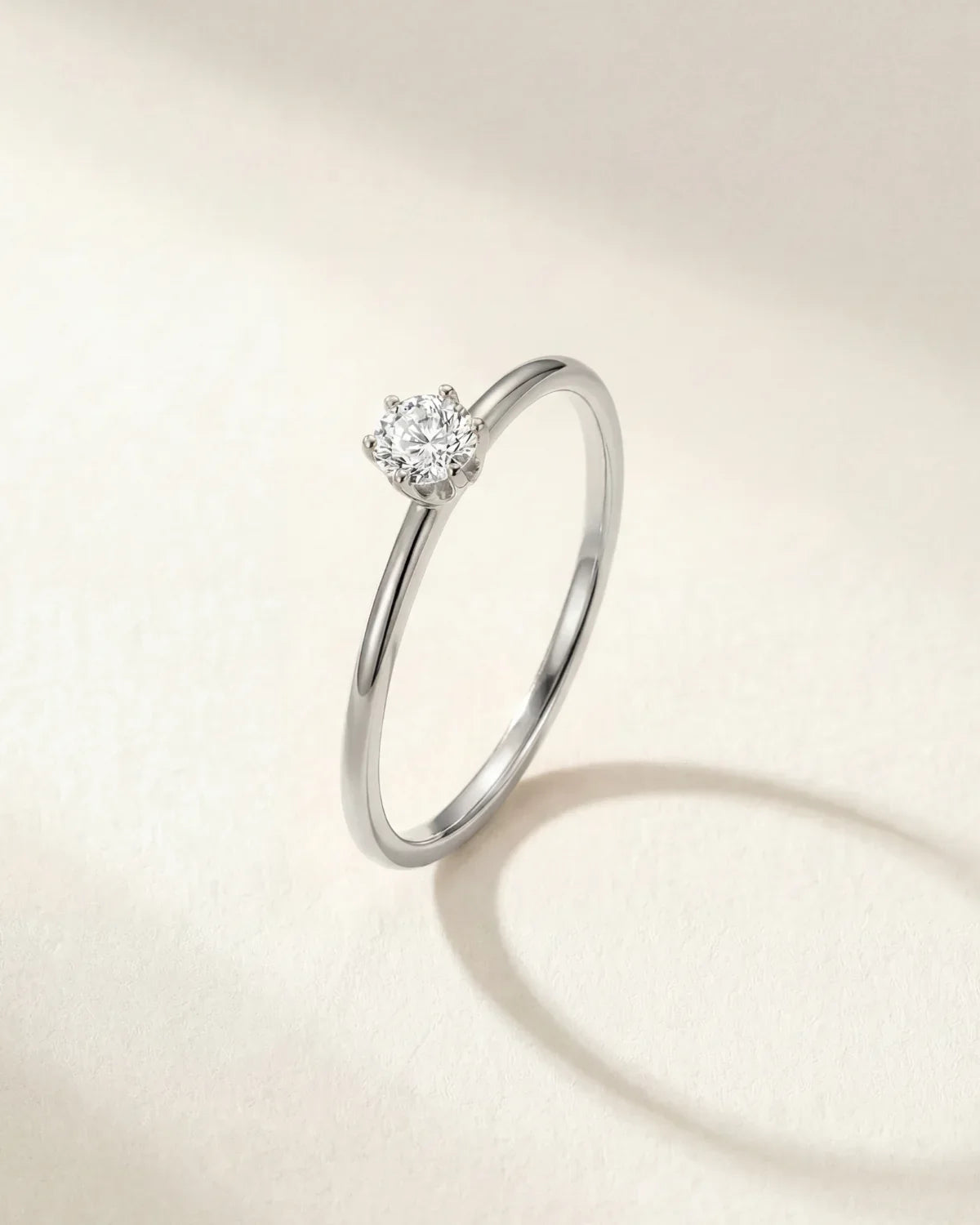 Silver-tone solitaire ring with round gemstone centerpiece