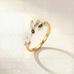Gold-tone elegant ring with blue and clear stone flower cluster
