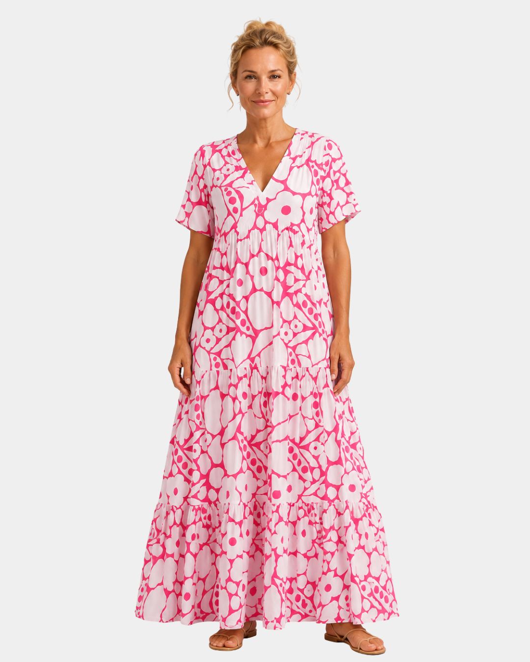 Pink floral maxi dress with V-neck, short sleeves, and tiered skirt