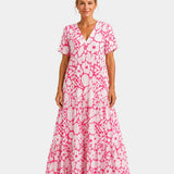 Pink floral maxi dress with V-neck, short sleeves, and tiered skirt