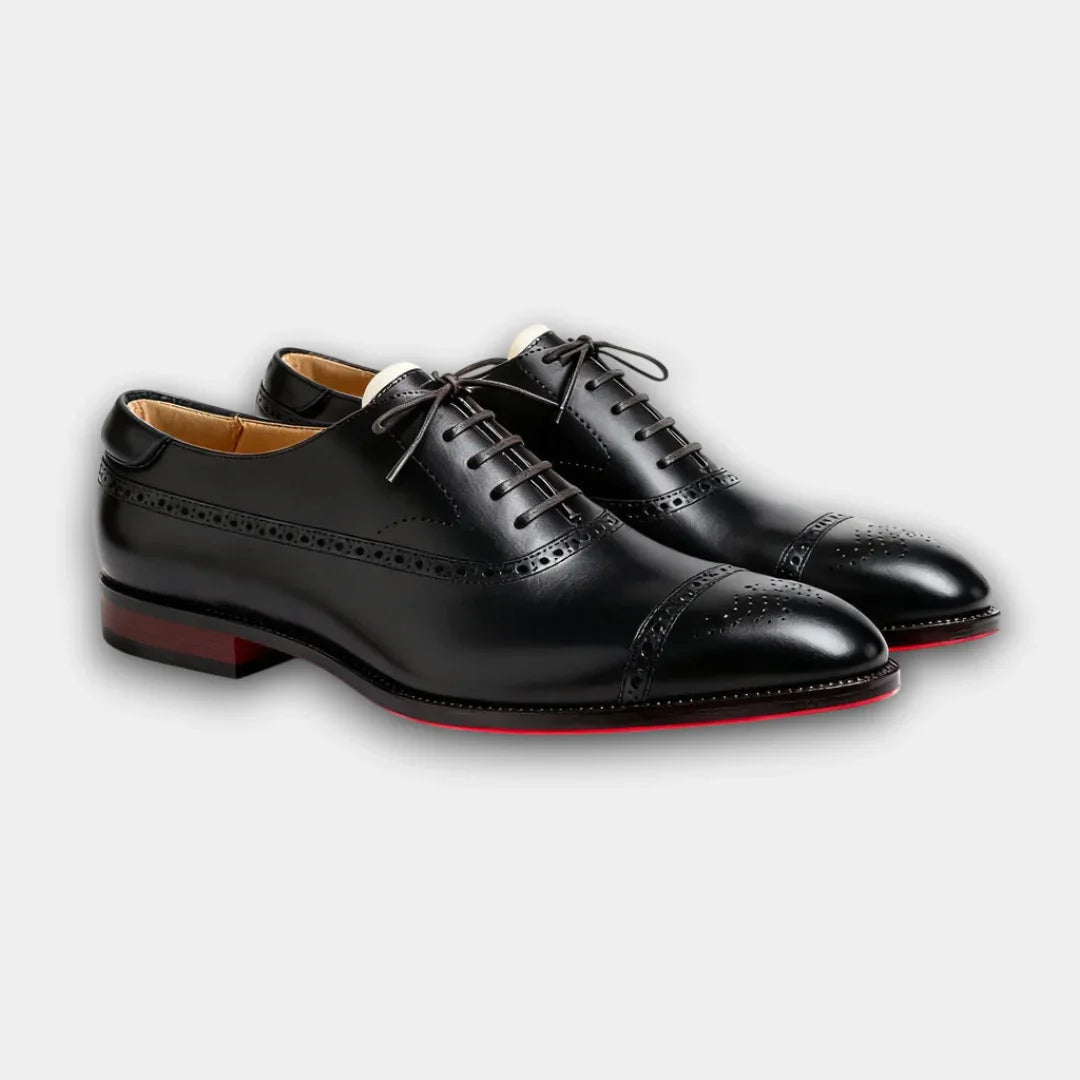 Black lace-up brogue dress shoes with perforated detailing and cap toe