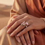Bronze floral spring ring with pink blossoms and tiny crystals, worn on hand
