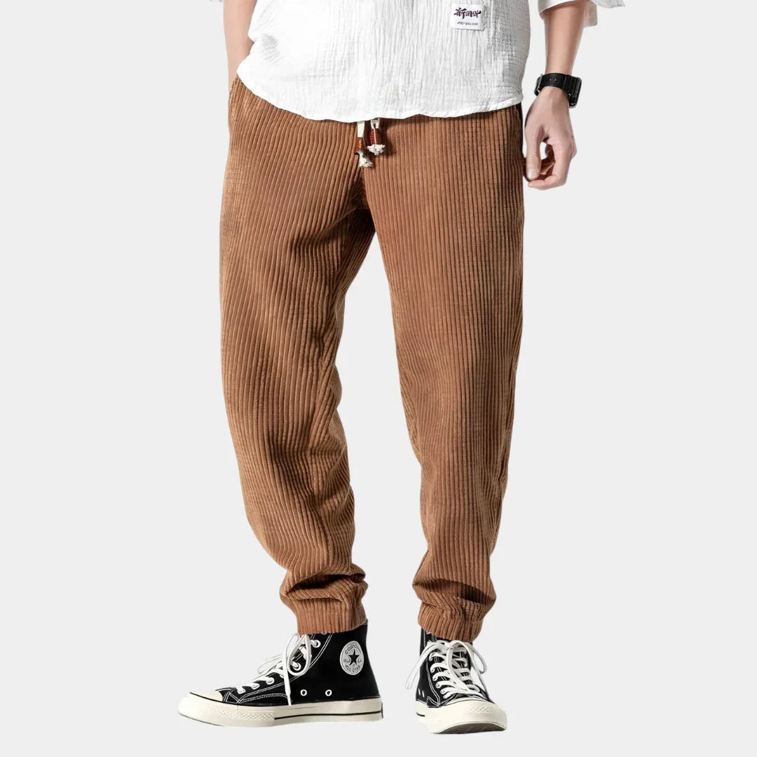 Brown corduroy pants with ribbed texture and button fly