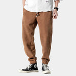 Brown corduroy pants with ribbed texture and button fly