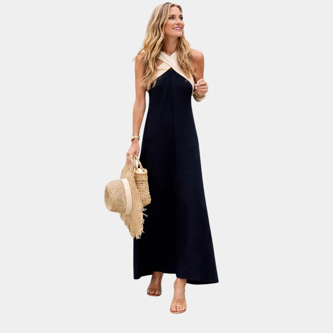 Maxi dress with crossed halter straps, dark sleeveless, flowing maxi-length hem