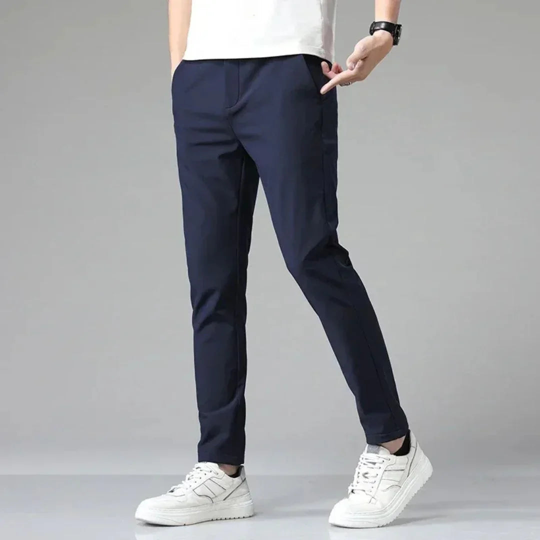 Men's navy blue slim-fit dress pants with zip fly and tapered leg