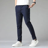 Men's navy blue slim-fit dress pants with zip fly and tapered leg