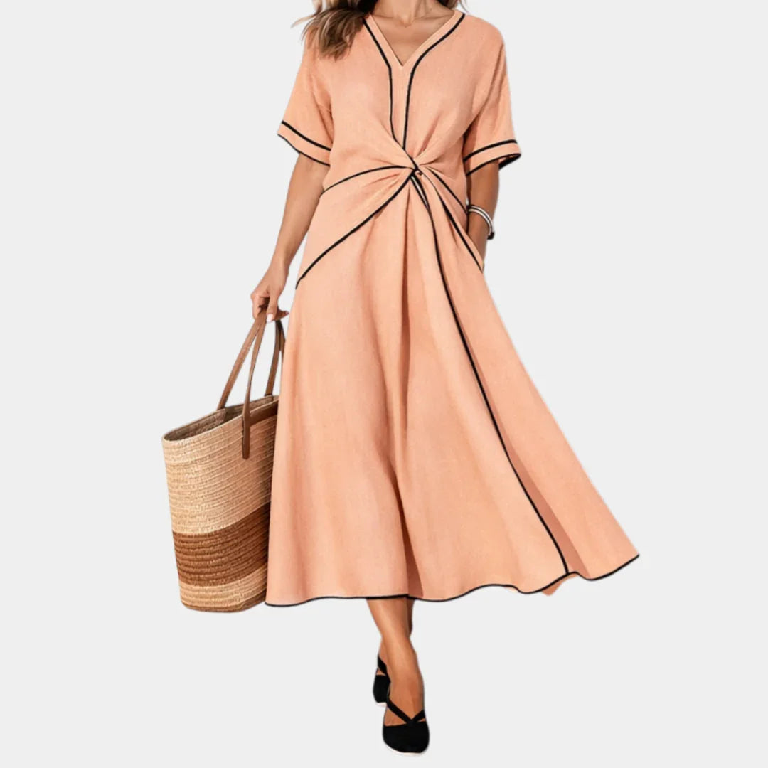 Peach V-neck spring dress with short sleeves, waist knot, and A-line midi skirt